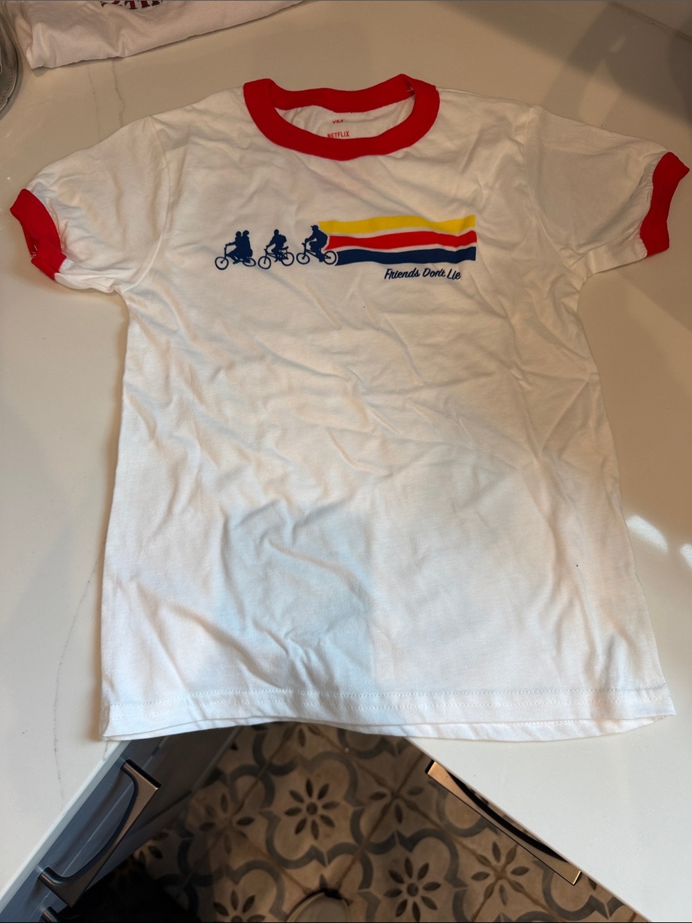 Netflix White Ringer Tee with Red Trim and Multicolor Bike Graphic
